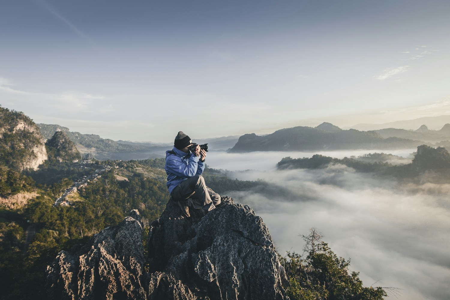 A photographer capturing a landscape outdoors — illustrative photography
